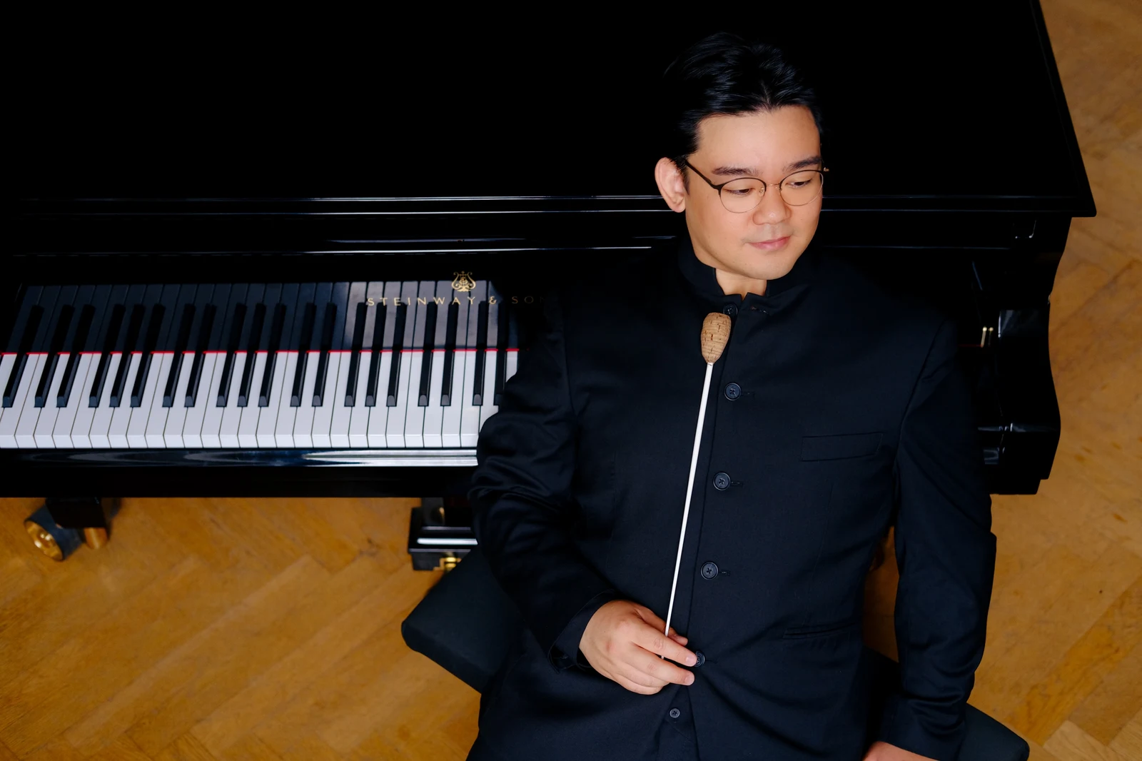 Sungwook Kim beside a piano and score