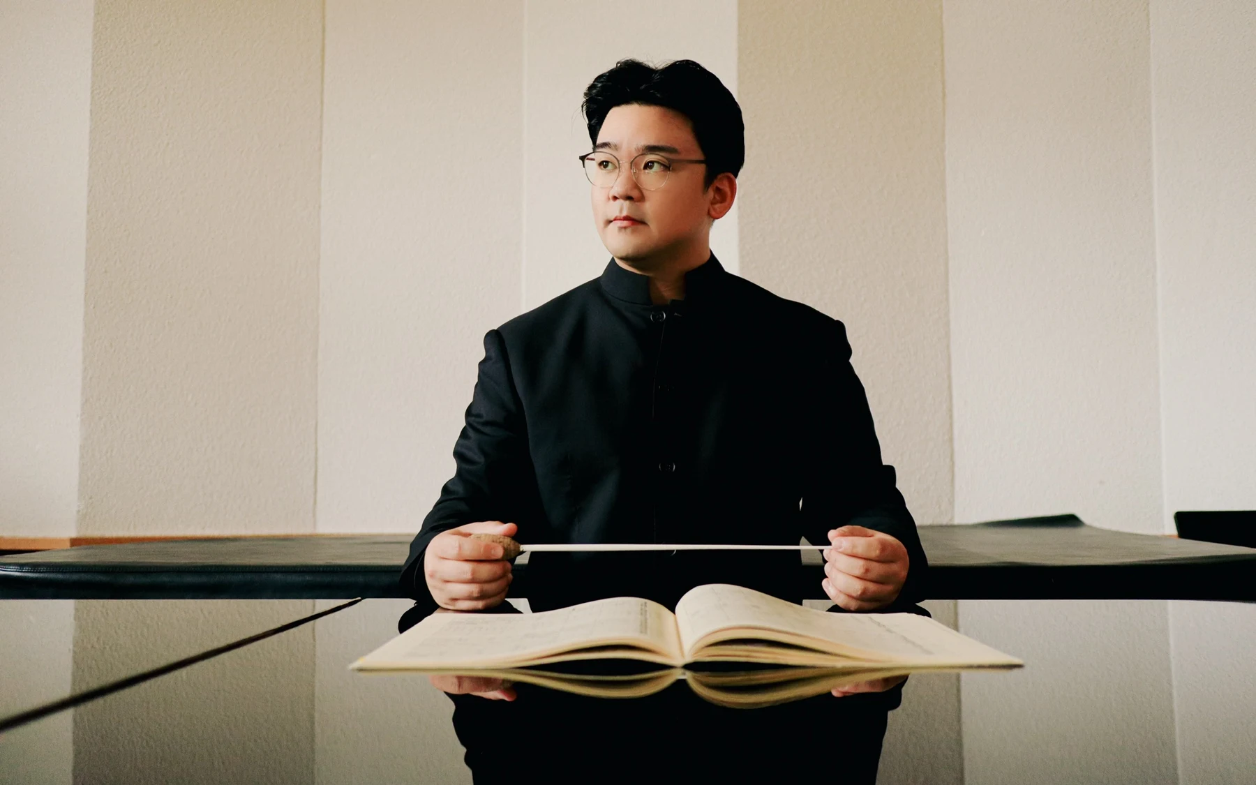 Sungwook Kim with baton and open score